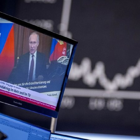 Russia's President Vladimir Putin appears on a television screen at the stock market in Frankfurt, Germany, Friday, Feb. 25, 2022. (AP Photo/Michael Probst)